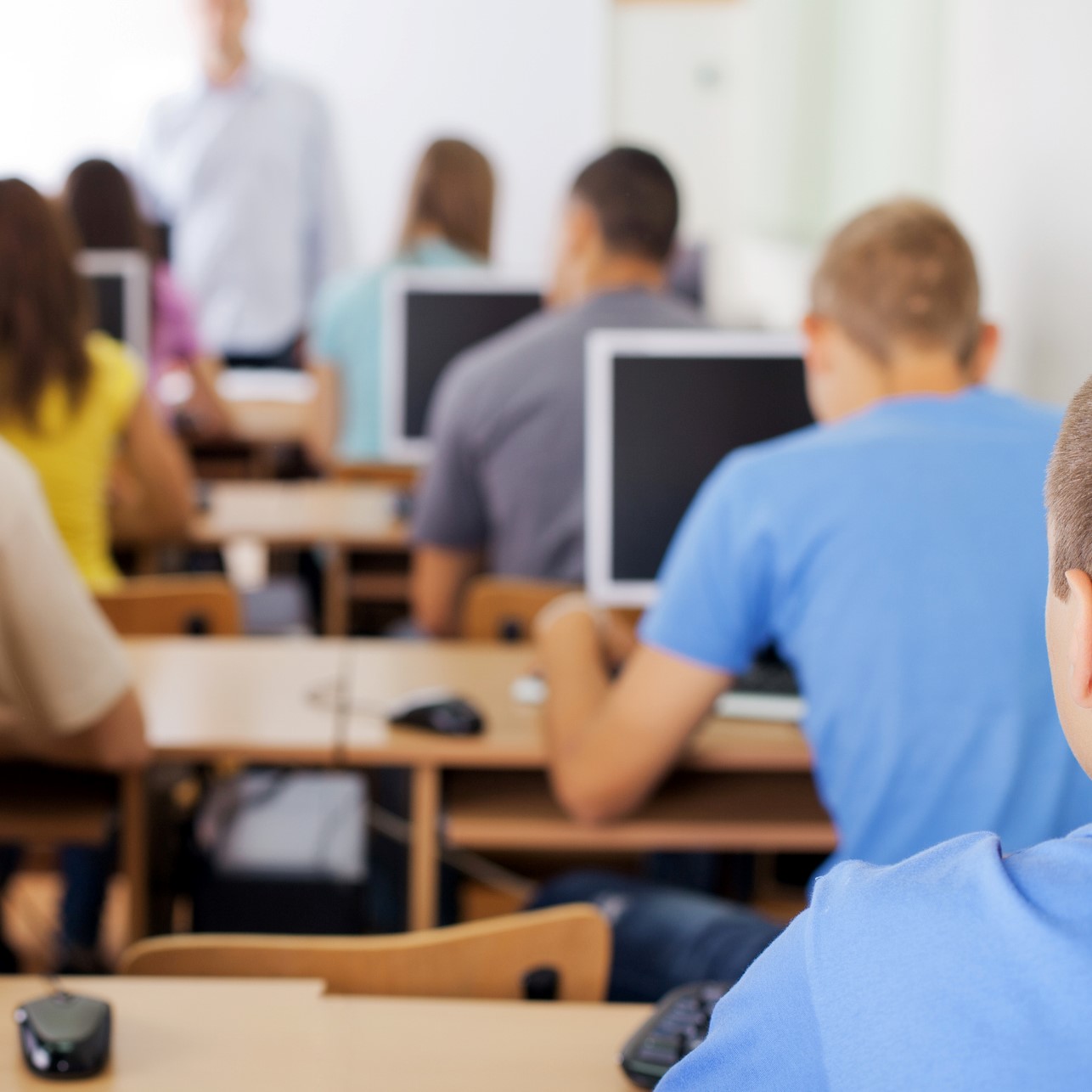 Teenage girl sitting in class and looking into the camera.jpg